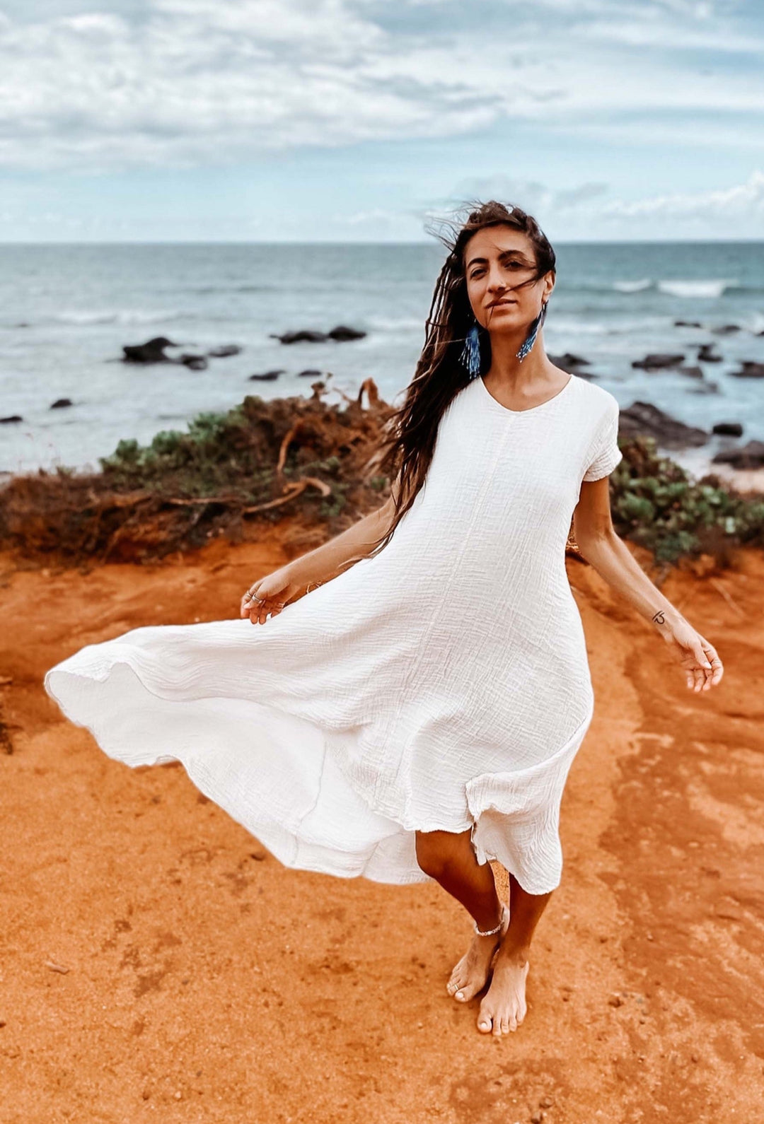 Woman wears long un-dyed white gauze cotton dress