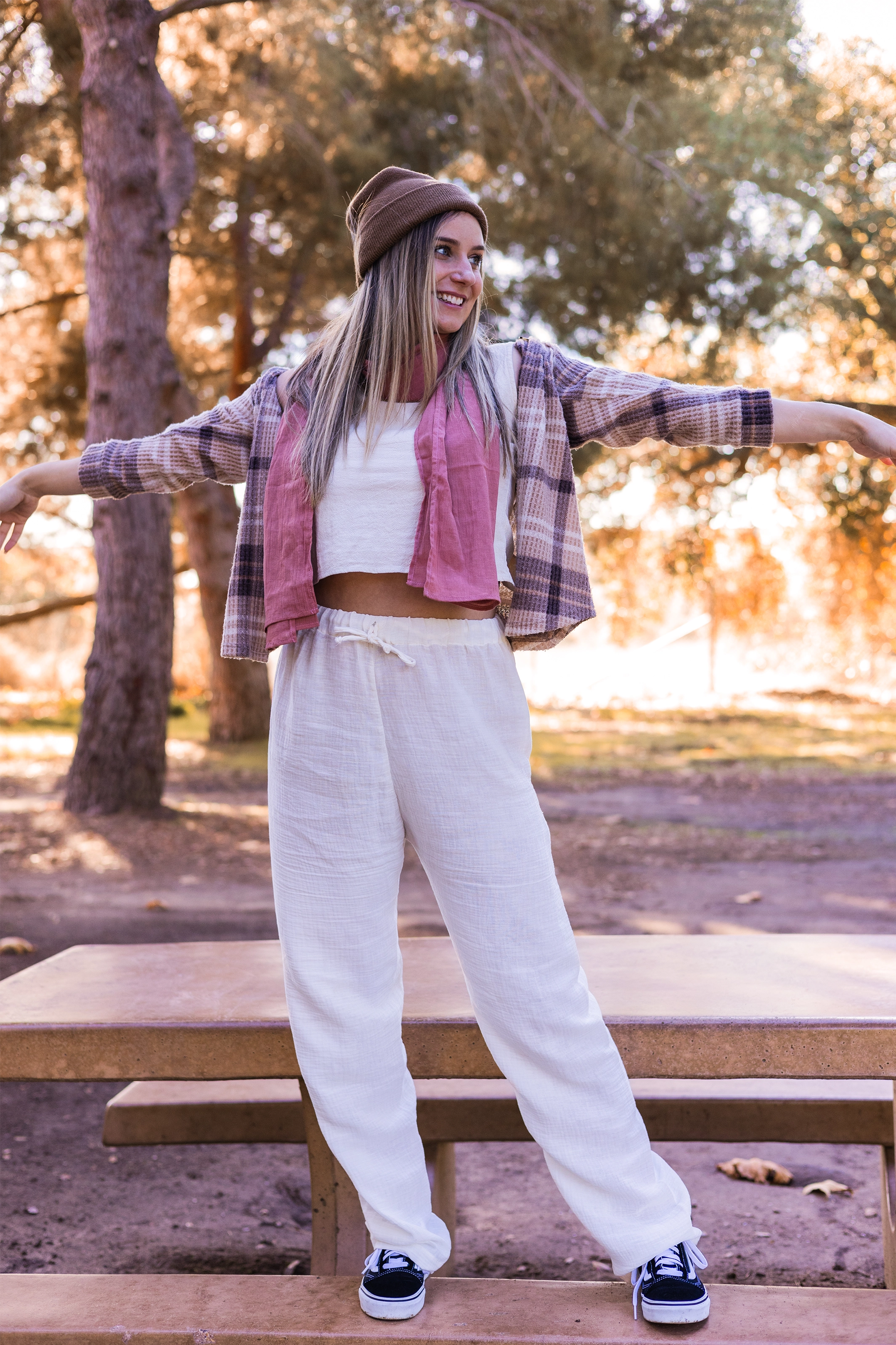 Woman shows off un-dyed white gauze cotton jogger pants.