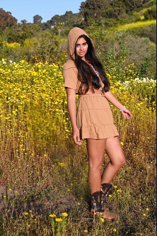 Model wears cropped hoodie and ruffled mini skirt.