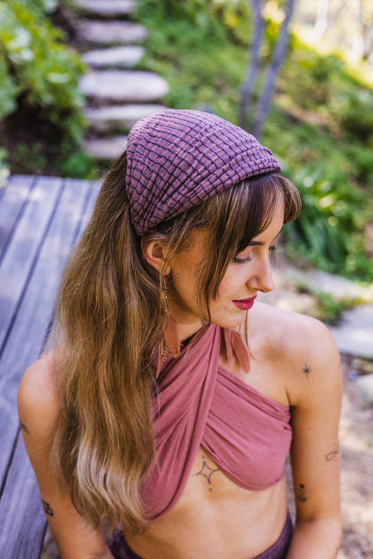 Woman wearing purple headband on head.