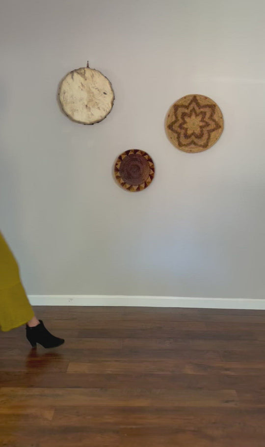 Female clothing model shows how to tie her long ruffle tank top into a knot in the front at her waist. She is wearing an aqua top, olive green bottoms and black ankle boots. She walks in, turns and walks out.