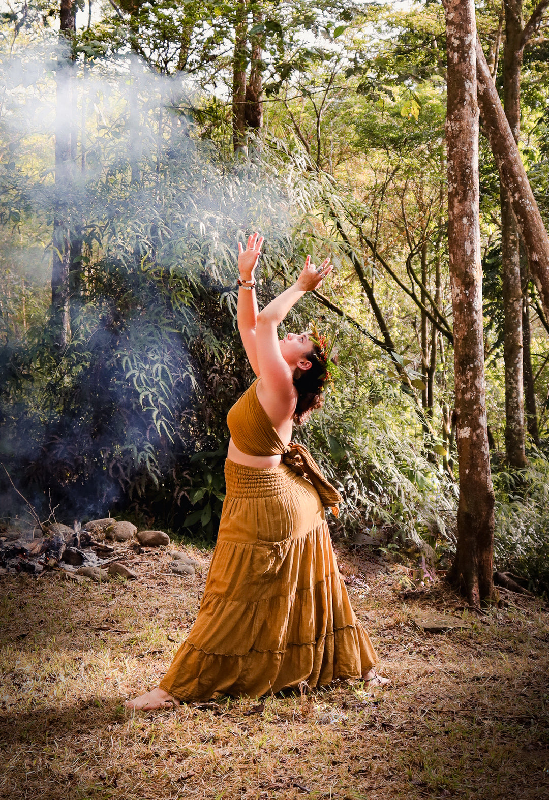 Model is in gold top paired with long gold skirt. 