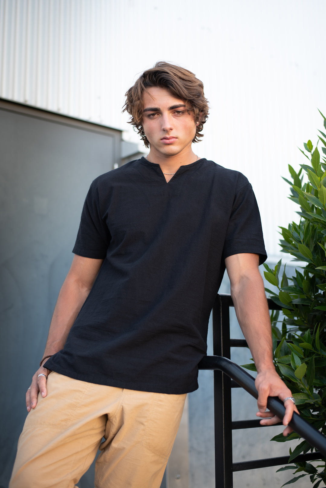 Model wears black gauze tee