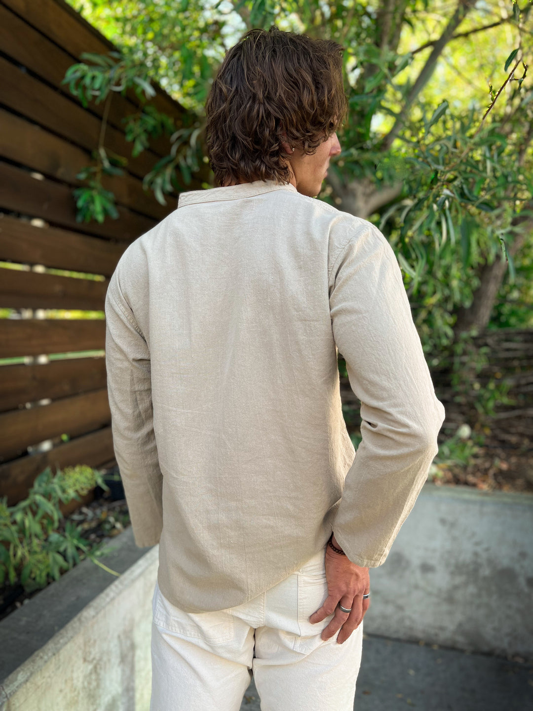 Model shows back of long-sleeve shirt and pants.