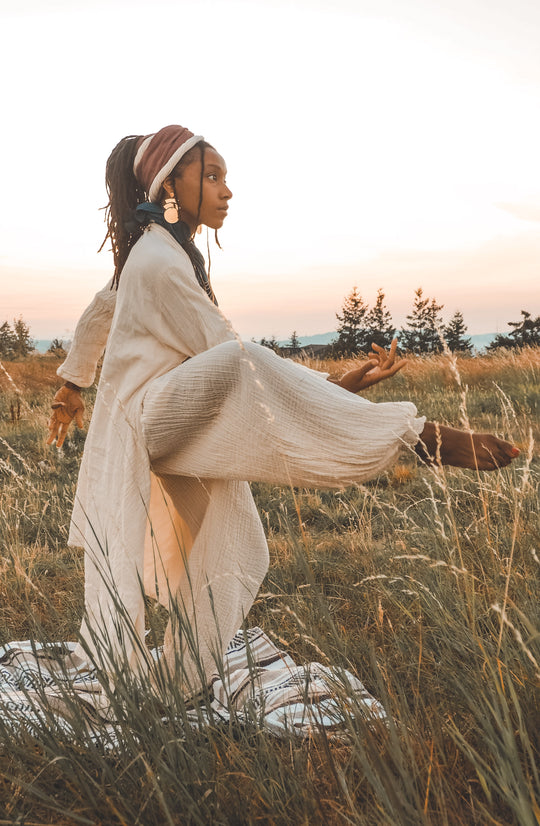 Woman models white un-dyed yoga clothing made from soft gauze cotton