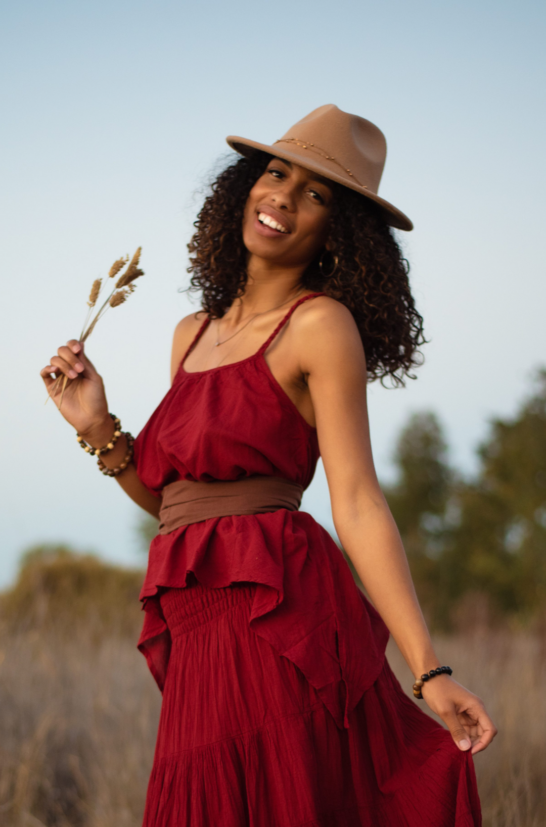 Model has on red gauze tank top and skirt.