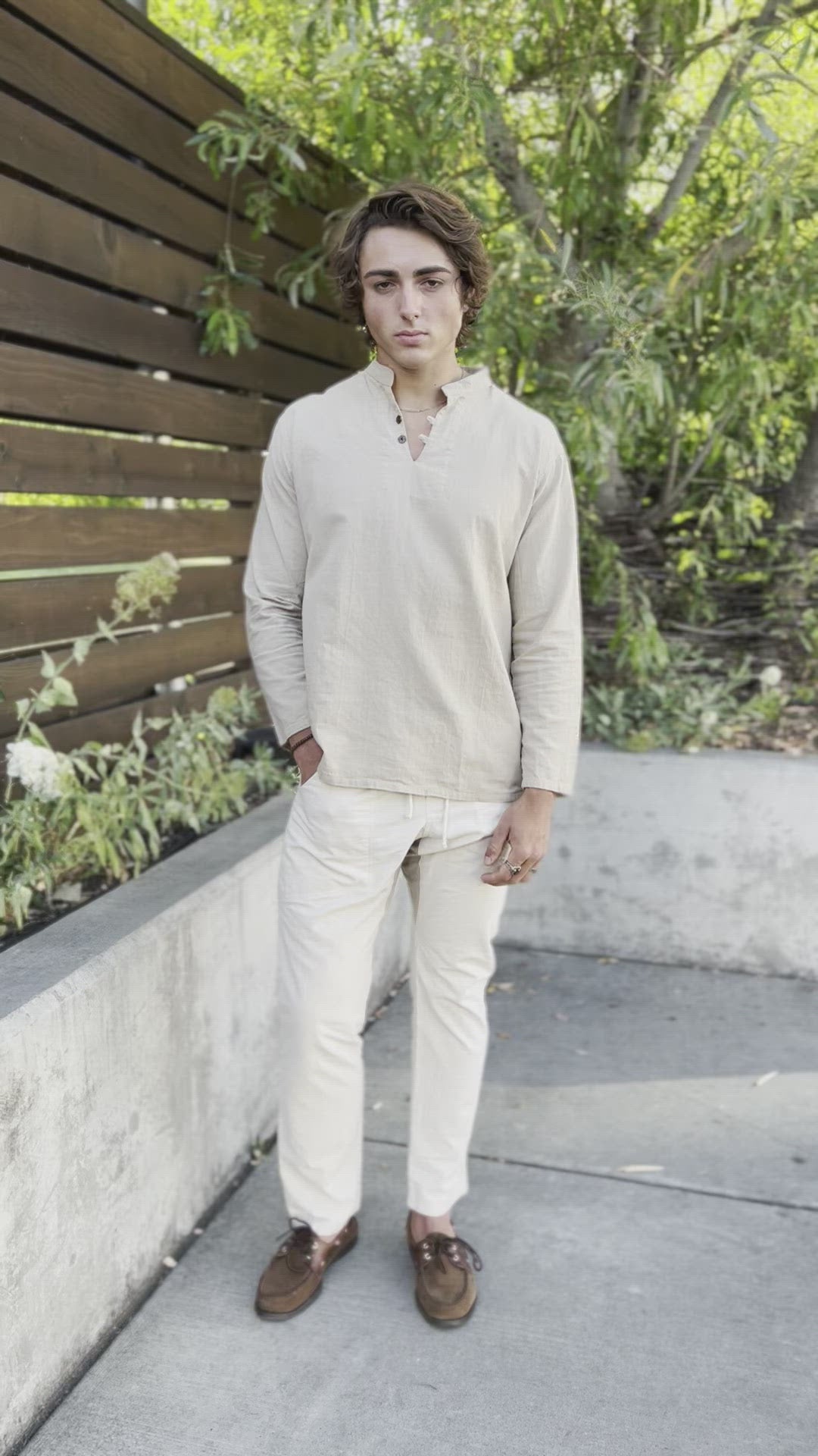 Man shows off natural gauze cotton shirt and un-dyed pants with brown shoes.